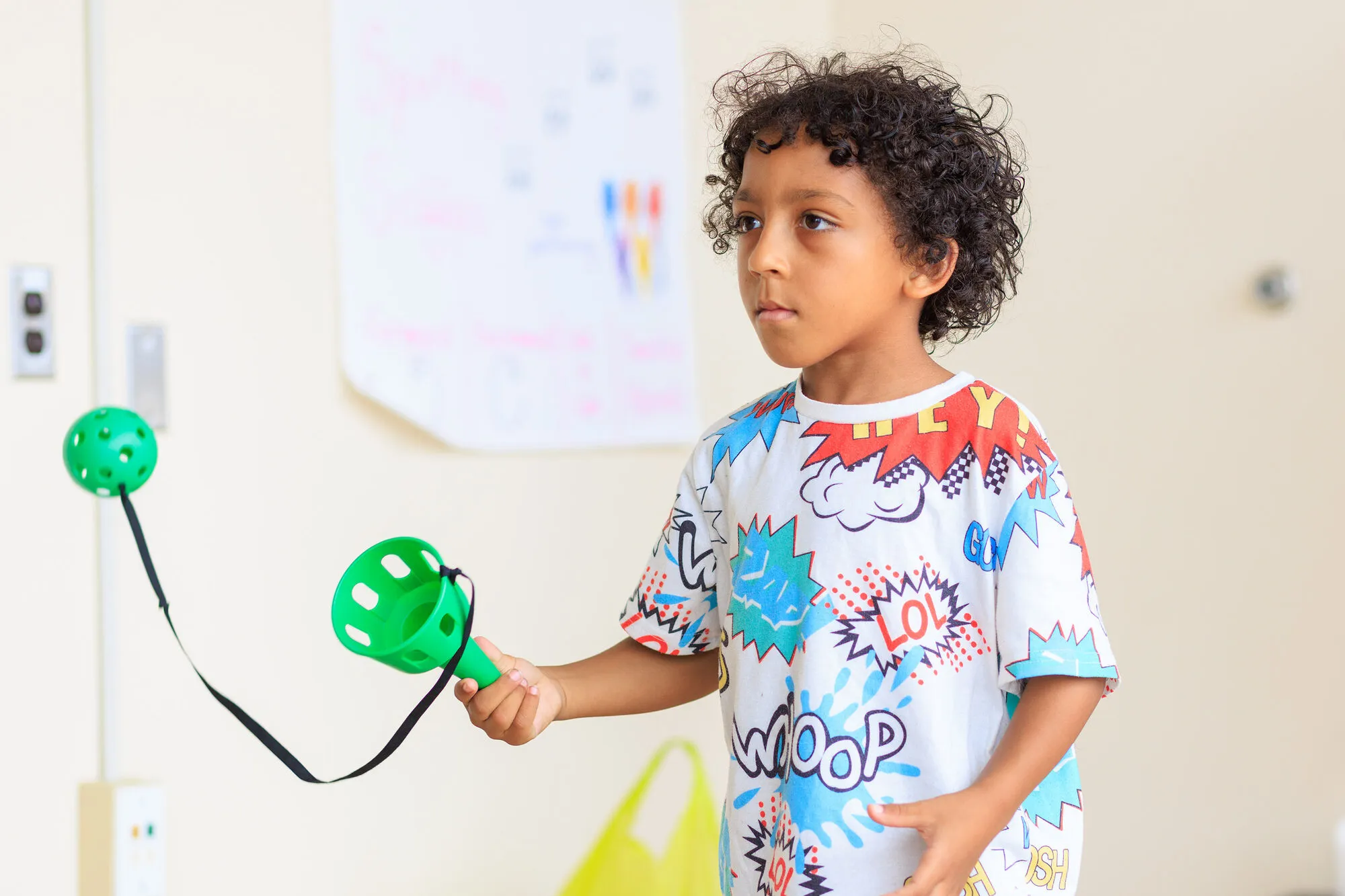 A child concentrating on a hand percussion instrument during a session
