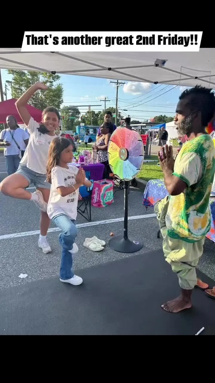 Children chasing bubbles at an outdoor community street fair